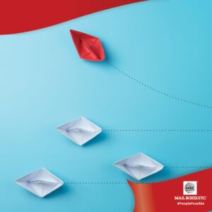 Red & Colour paper boats on blue background